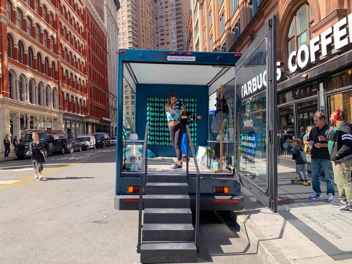 A branded mobile showroom vehicle set up for a retail brand activation.