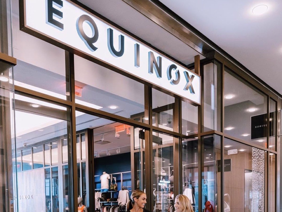 A branded activewear shop-in-shop trading inside the entrance of an Equinox fitness club.